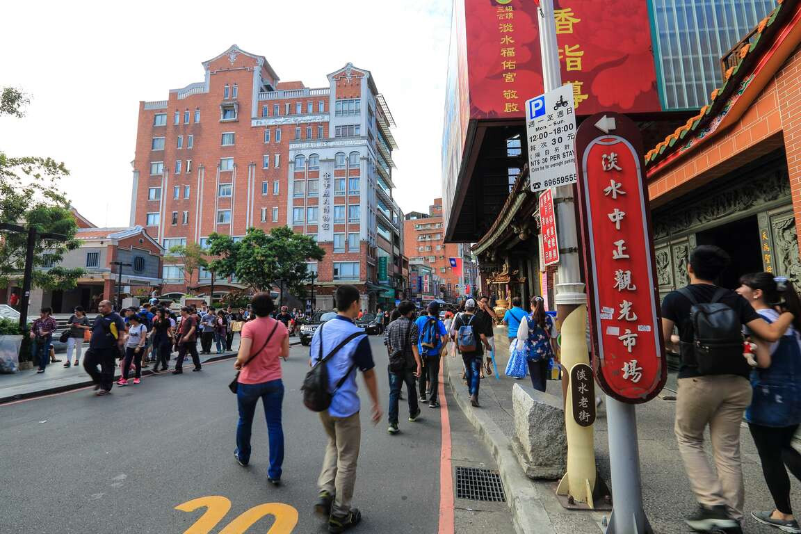 People enjoying food at Tamsui Old Street