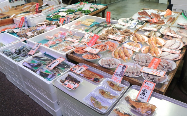 Inside Omicho Market in Kanazawa, showcasing fresh seafood and other local produce.