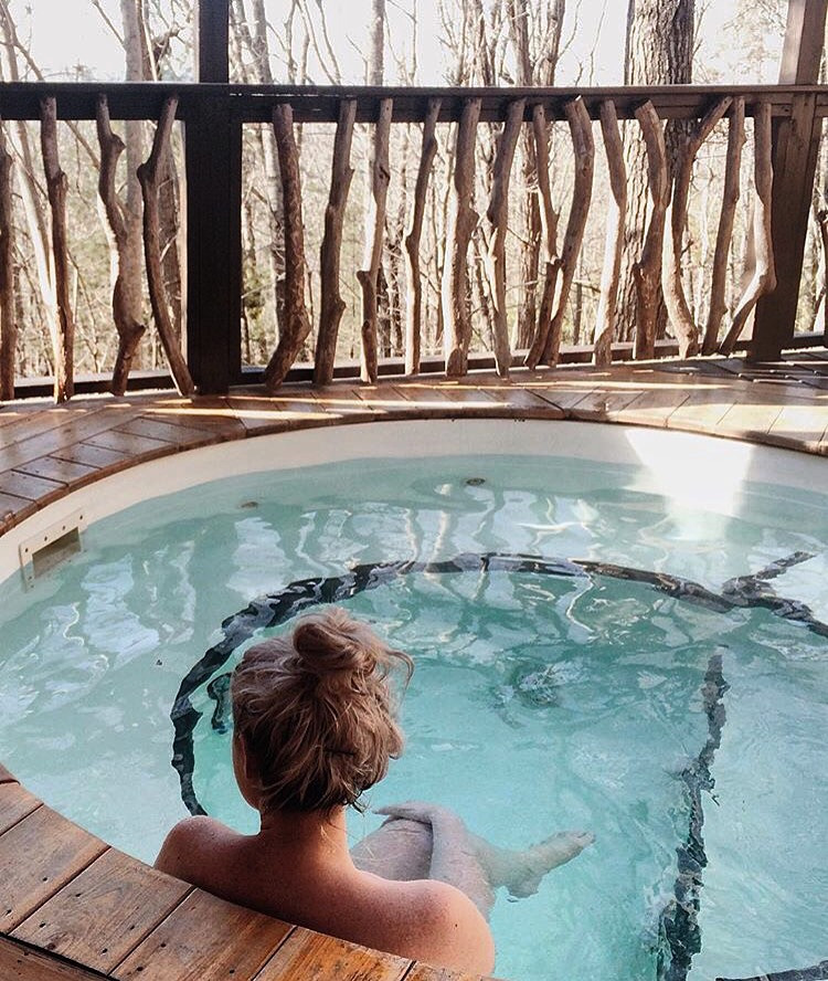 Couple relaxing in a private hot tub at Shoji Spa and Lodge immersed in nature