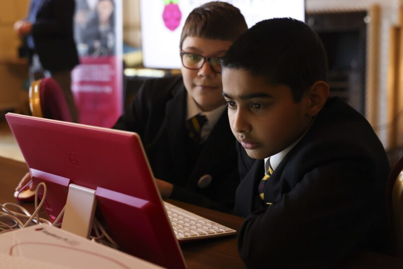 A group of young coders collaborates during a Code Club session at Number Ten Downing Street, fostering teamwork and digital creativity.