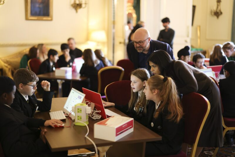 Students focused on Raspberry Pi computers during a Code Club session at Ten Downing Street, learning digital skills.