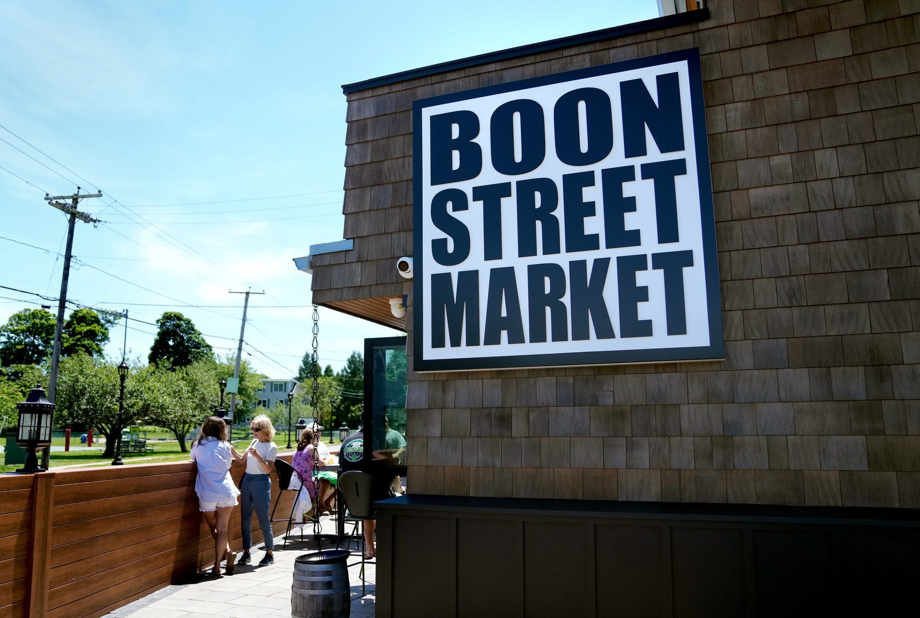 Exterior view of Boon Street Market in Narragansett, showcasing its revitalized historic building and outdoor seating area.