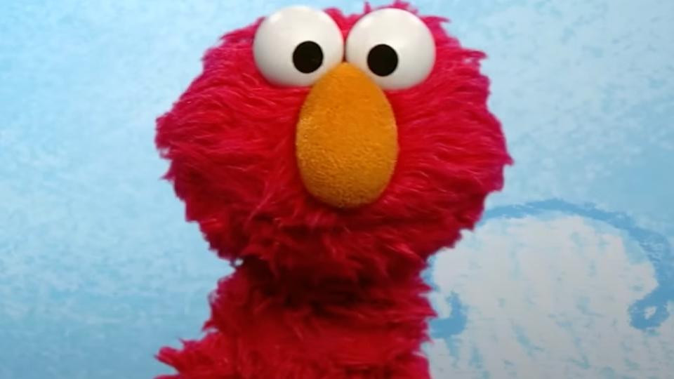 Beloved Sesame Street character Elmo smiles, representing the long-running children's program facing uncertain future after reports of cancellation.
