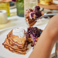 Promotional image showcasing a seasonal menu launch at True Food Kitchen, emphasizing fresh and vibrant ingredients.