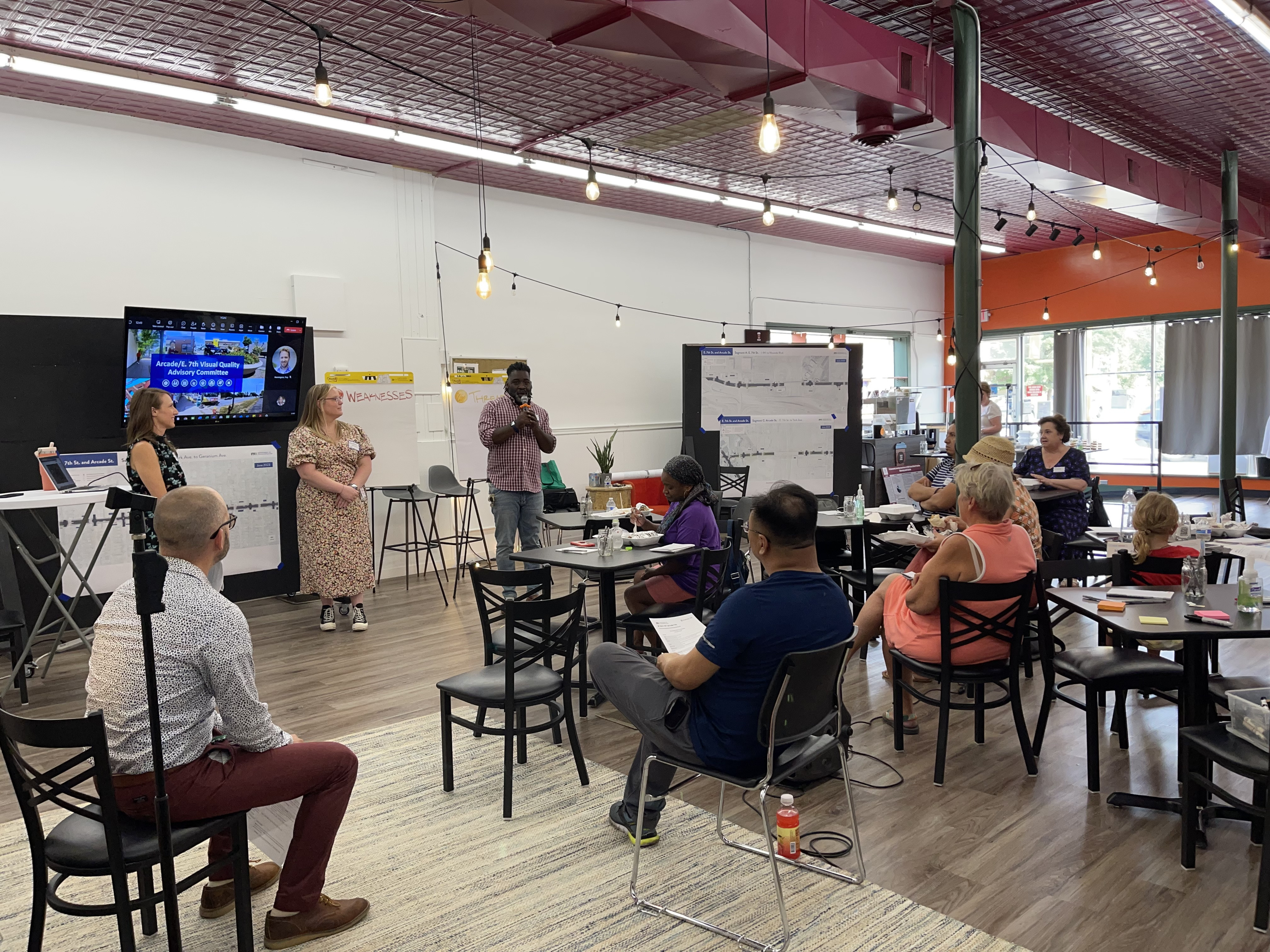Visual Quality Advisory Committee members in a meeting with project presenters discussing East 7th Street improvements.