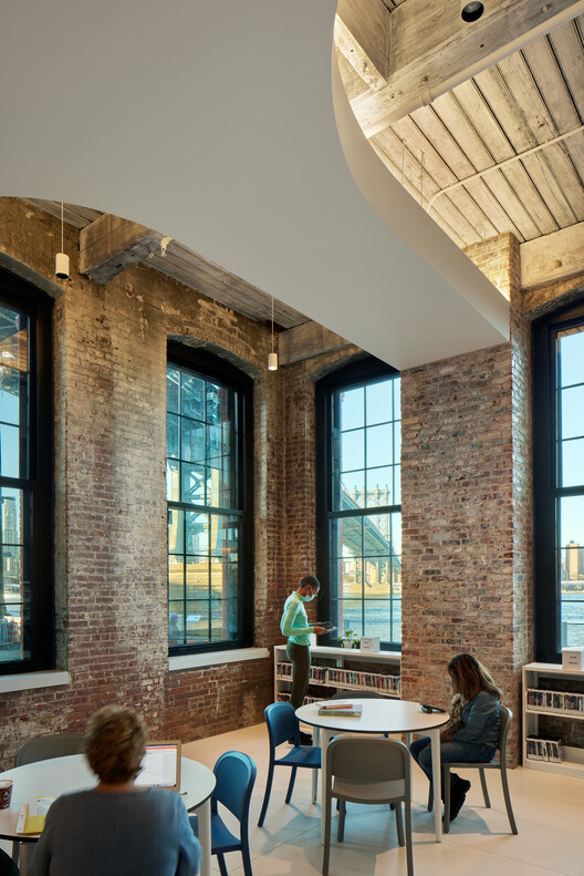 Flexible interior layout of Adams Street Library with tables and chairs, catering to various library activities.