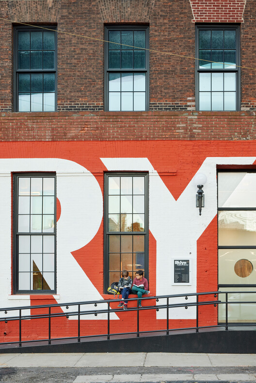 Close-up of Adams Street Library's exterior, showing the brickwork and window design in the DUMBO Historic District.