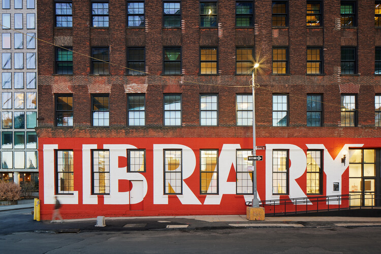 Exterior view of Adams Street Library in Brooklyn showcasing its brick facade and large windows, designed by WORKac.