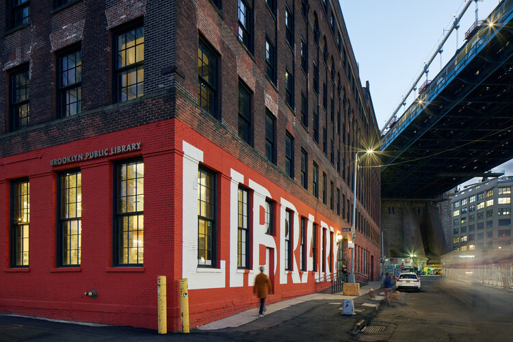 Adams Street Library's facade with expansive windows, highlighting the library's connection to the DUMBO neighborhood.