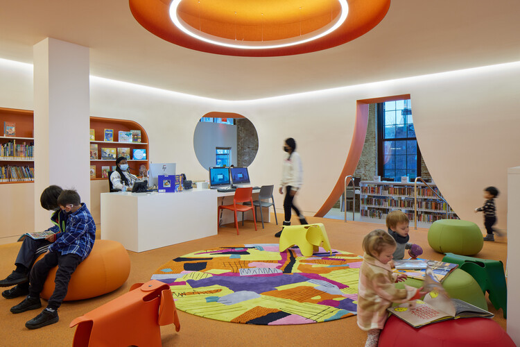 Cozy reading nook within Adams Street Library, featuring comfortable seating and accessible bookshelves.