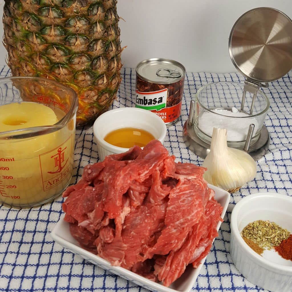 Ingredients for making Tijuana street tacos in an air fryer, featuring flap meat, pineapple, and spices.