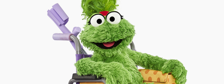 Ameera Sesame Street Muppet character smiling in a purple shirt