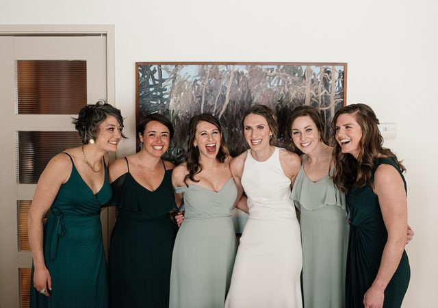 Wedding party in chic green dresses outside Anchorage Museum, before heading to King Street Brewing