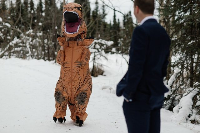 Bride in a T-Rex costume approaching the groom for a surprise first look at King Street Brewing