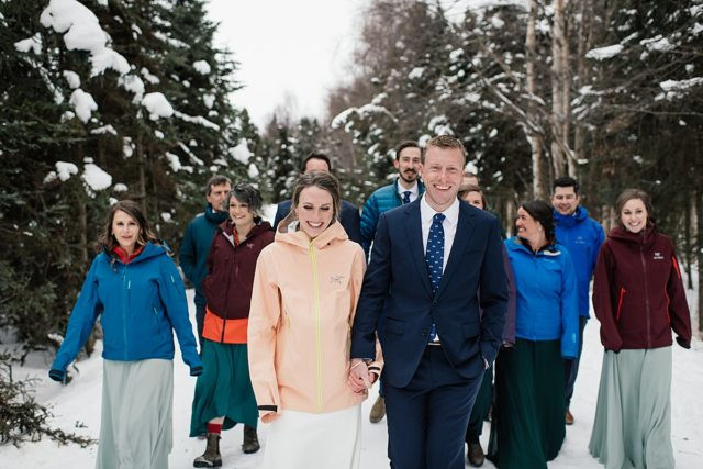Bridesmaids and groomsmen posing for portraits at the Anchorage Museum during winter wedding