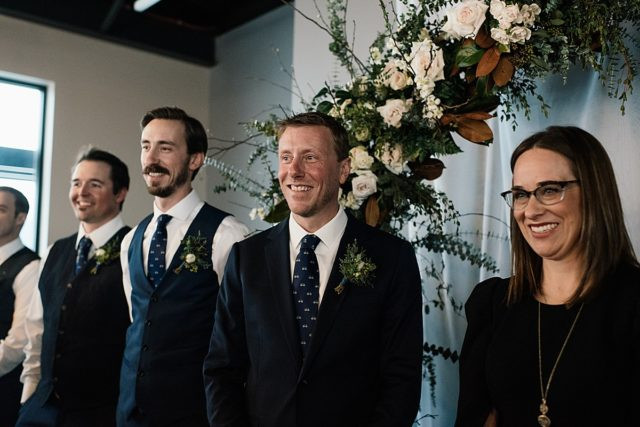 Emotional moment during speeches at Anchorage wedding reception, captured in photography