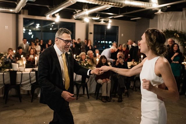 Alaska wedding photographer capturing bride and groom first dance at brewery venue