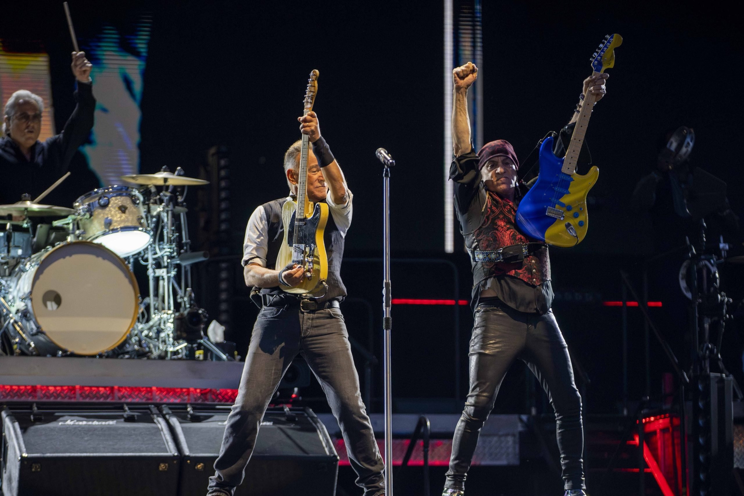 Bruce Springsteen interacting with band member during Philadelphia concert performance.