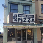 Center Street Pizza storefront in downtown Logan, Utah, inviting diners for a taste of local pizza.