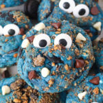 Close up of assorted Cookie Monster cookies topped with candy eyes.