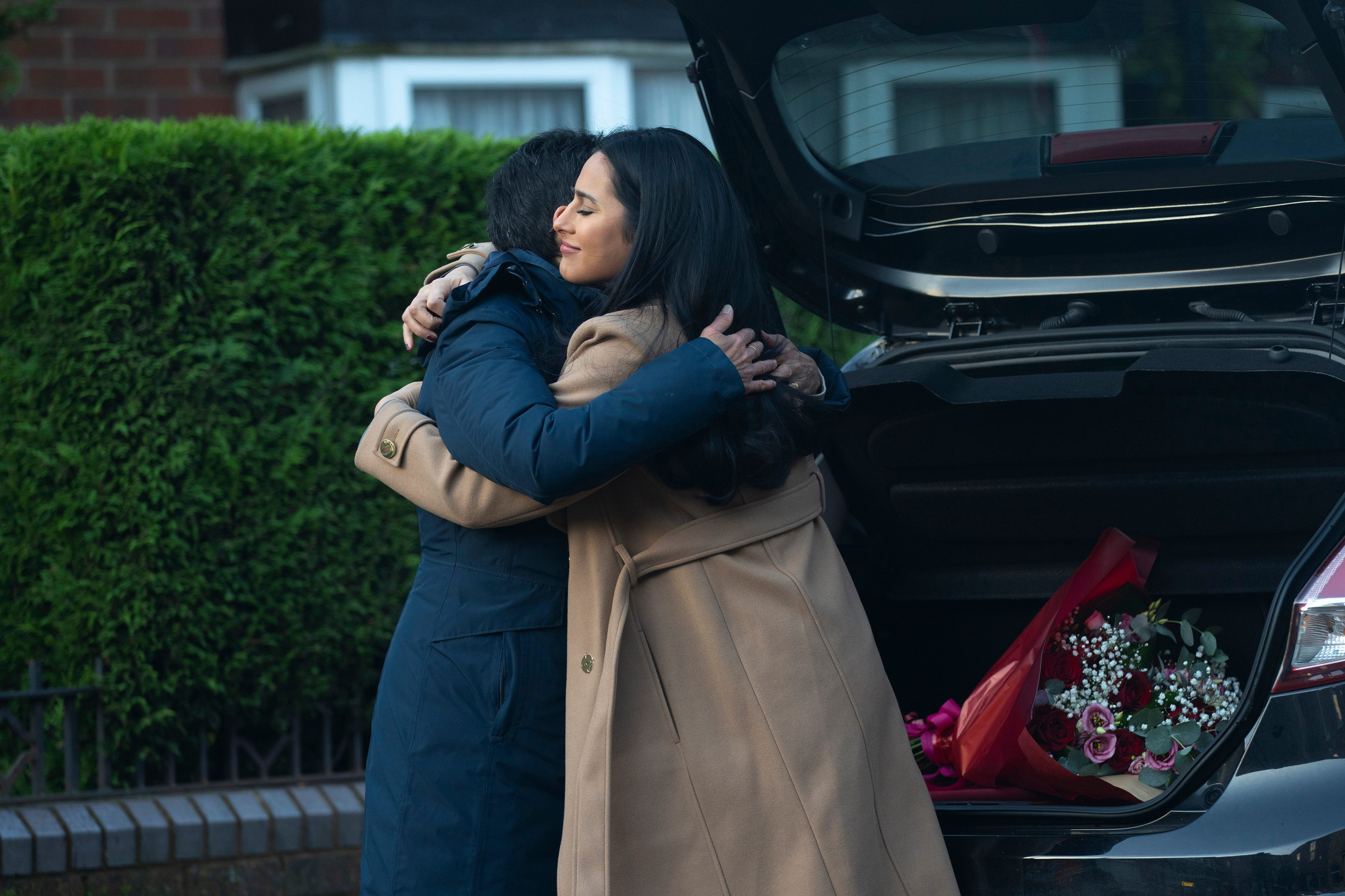 Yasmeen and Alya embracing next to a car, a poignant street spoilers moment in Coronation Street.