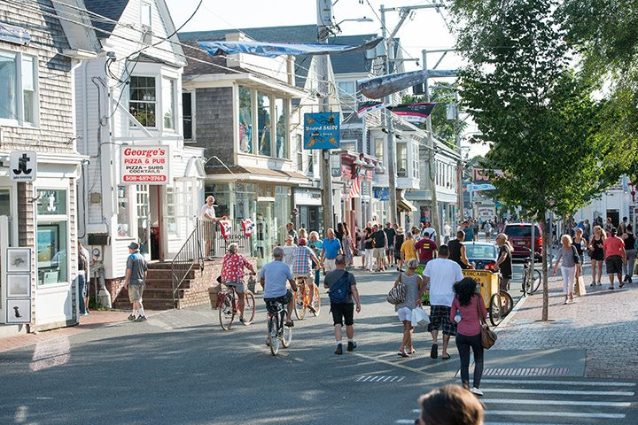 Vibrant storefronts and bustling pedestrian traffic on Commercial Street in Provincetown, Massachusetts.
