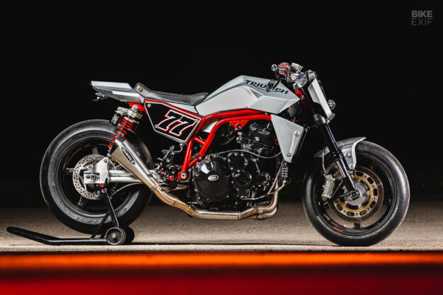 Custom Triumph Speed Triple 1050 street fighter with aftermarket exhaust and single headlight conversion