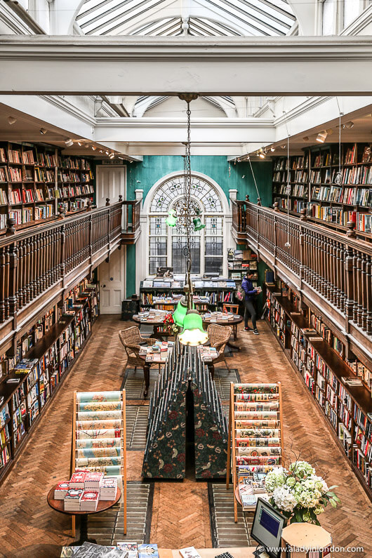 Interior of Daunt Books on Marylebone High Street, London, showcasing its unique mezzanine and book collections.