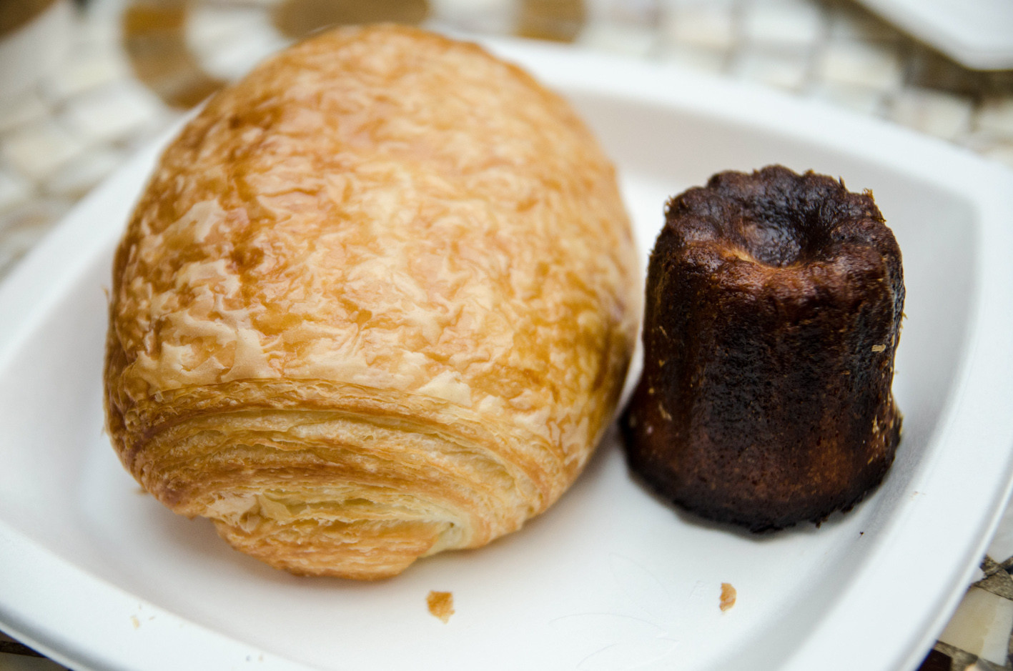 Dark brown Cannelé de Bordeaux pastries with a caramelized crust at Dominique Ansel Bakery