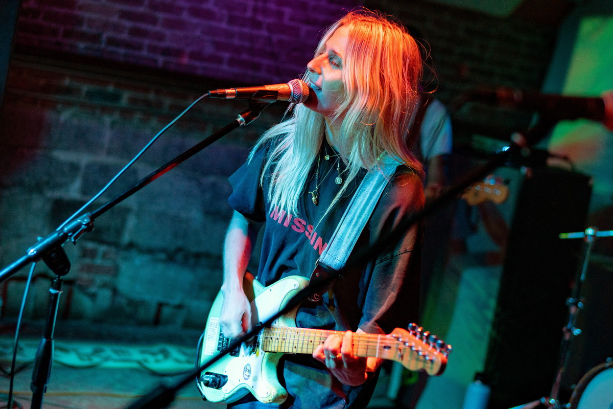 Bully's lead singer, Alicia Bognanno, energetically engaging with the audience at Bond Street Bar during their September 1st show.