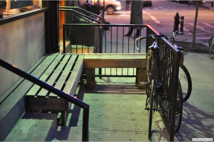 Benches outside Ninth Street Espresso on 9th Street, inviting customers to relax and enjoy their coffee in Alphabet City.