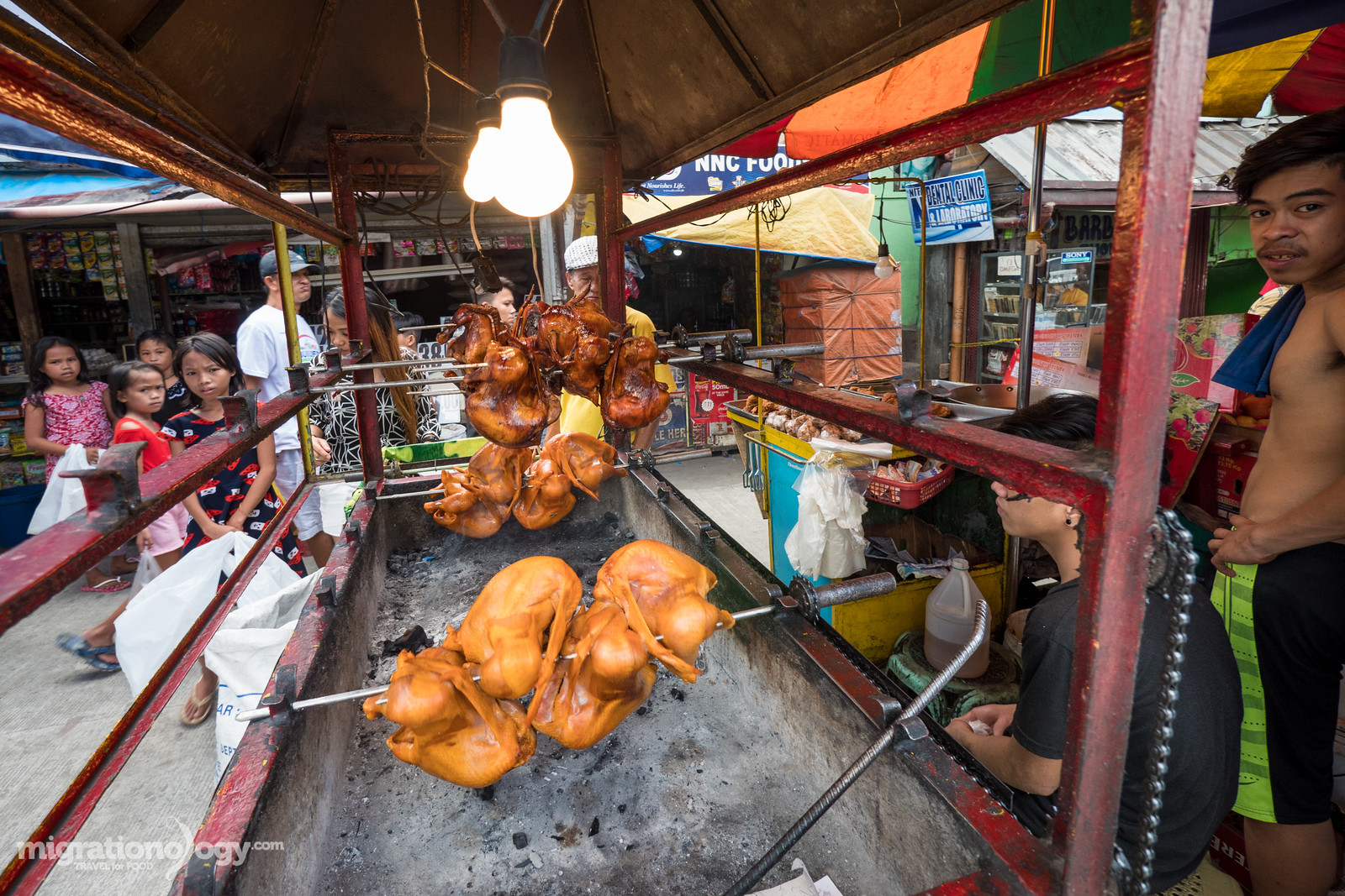 Lechon Manok, Filipino roasted chicken, often sold as street food in Manila.