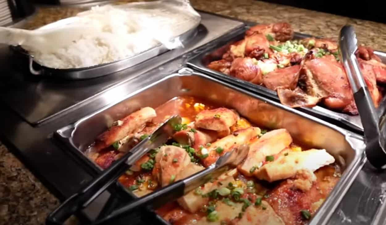 A buffet station featuring Hawaiian dishes such as Kalua pork and macaroni salad at Garden Buffet