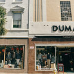 M. Dumas & Sons storefront on King Street Charleston, showcasing classic men's clothing.