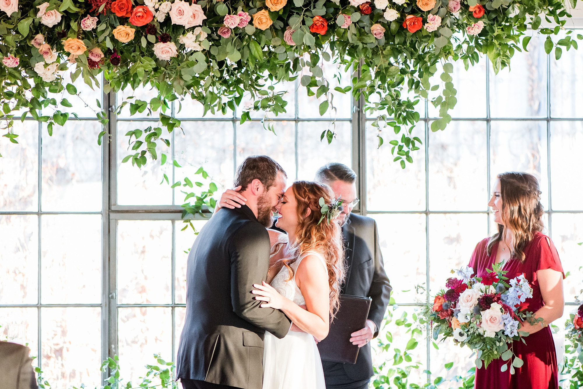 Bride and Groom Kissing in Front of Brick Wall at Hickory Street Annex