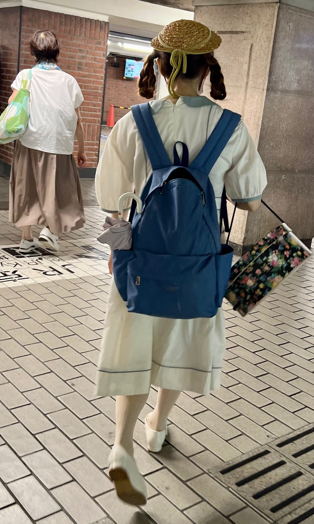 Harajuku street style image of a woman in a colorful kawaii-inspired outfit, representing Japanese youth subcultures in fashion.