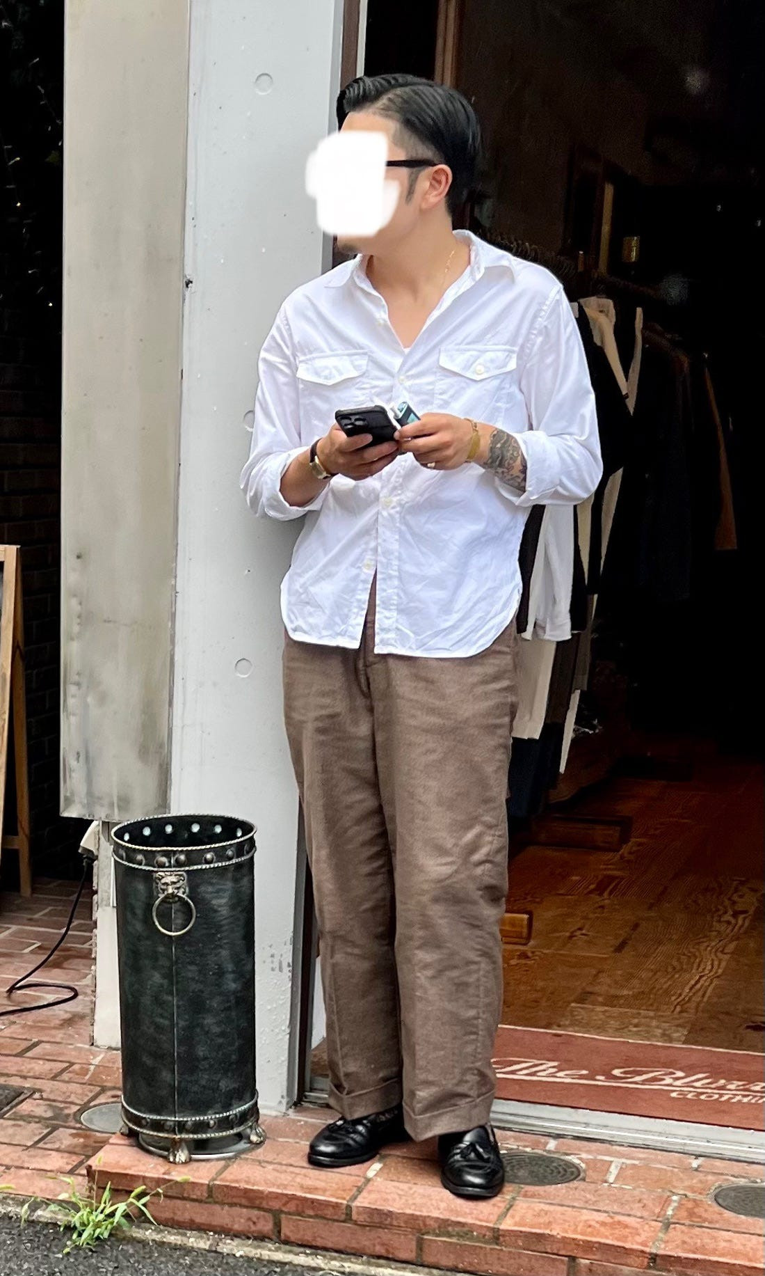 Street style image of a person in a uniquely styled denim jacket and pants, showcasing individual expression in Japanese fashion.