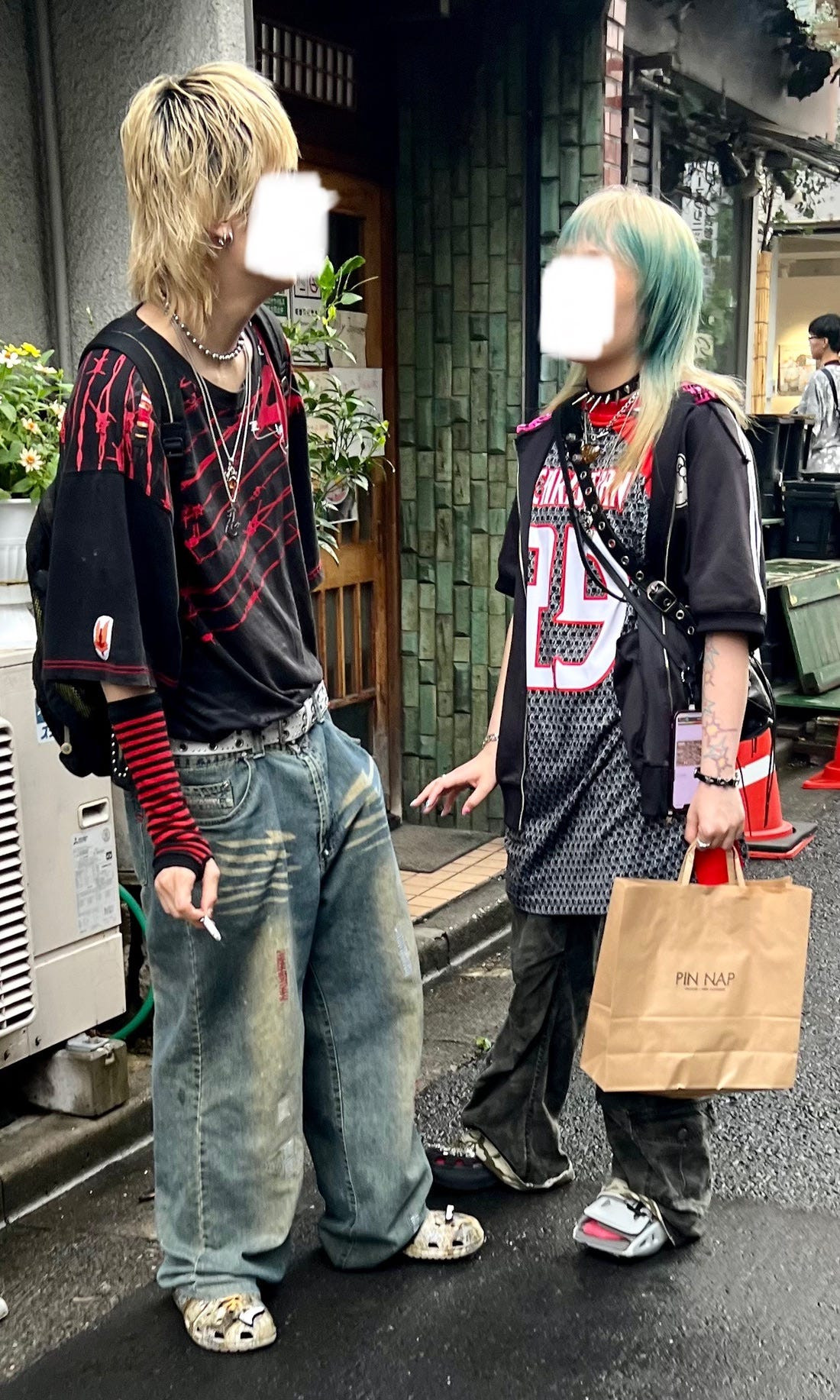 Street style photograph of friends with similar fashion aesthetics walking together, highlighting osoroi among friend groups in Japan.