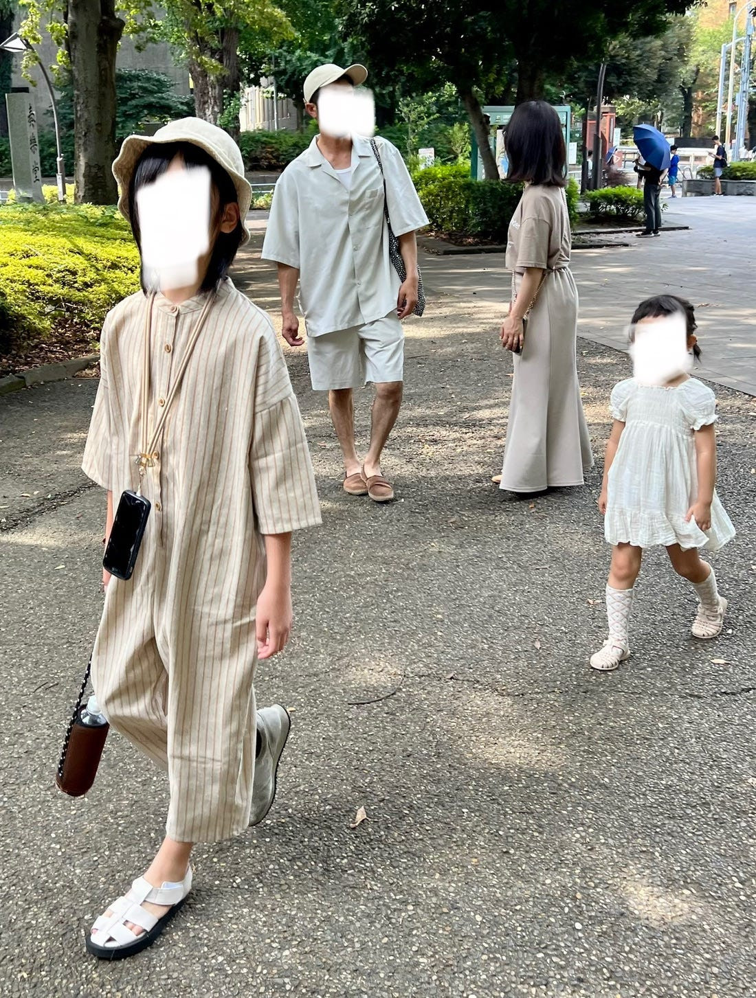 Street style photograph of a mother and daughter shopping in Osaka, both wearing similar styles, exemplifying osoroi in everyday Japanese life.