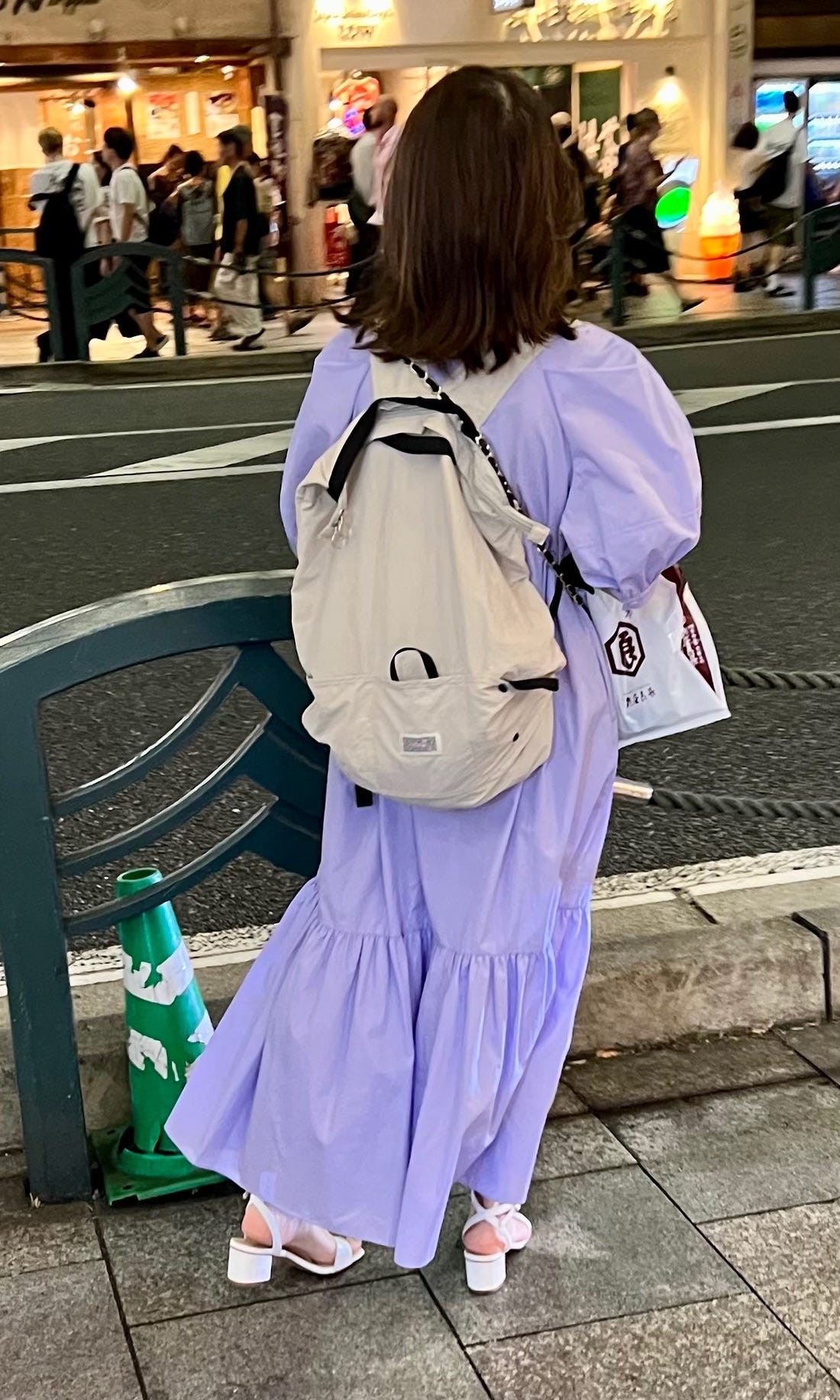 A person in Tokyo wearing an oversized shirt and wide trousers, demonstrating a relaxed yet fashionable Japanese street style look.