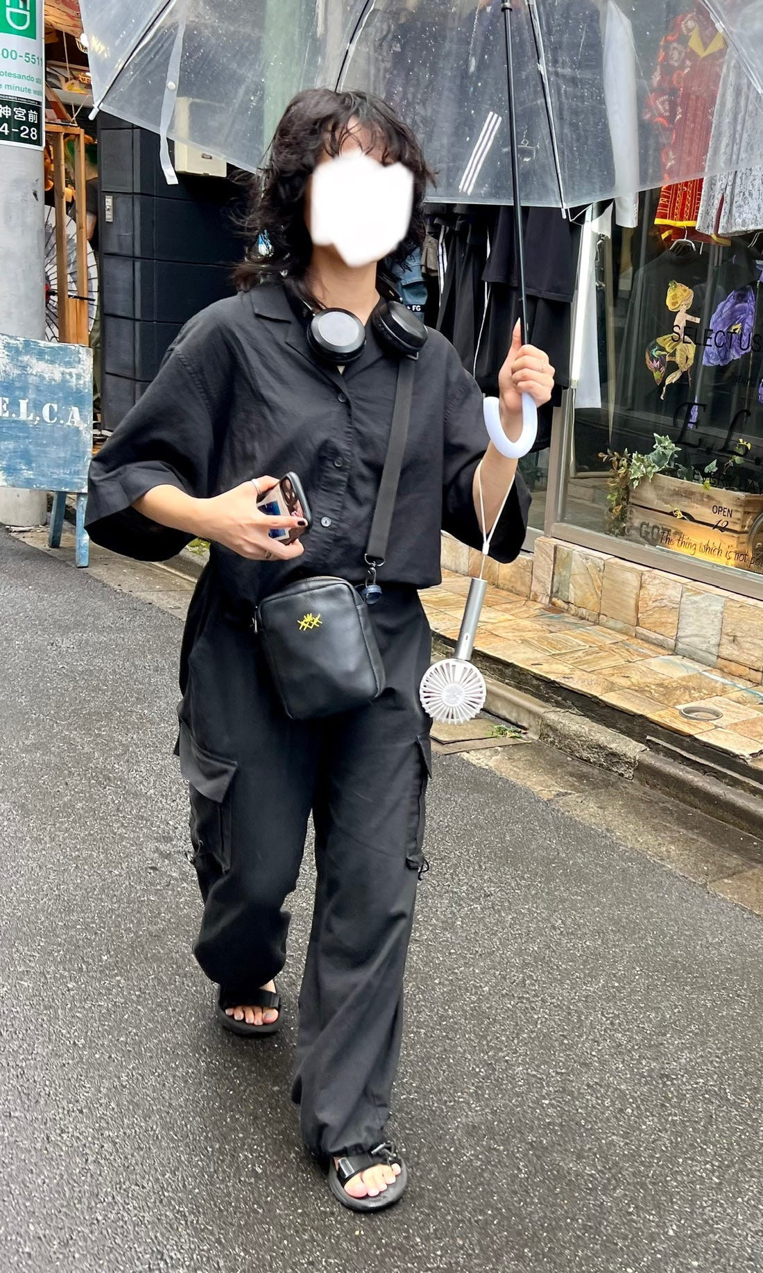 Street fashion image of a person in a stylish jumpsuit and sneakers, highlighting the blend of comfort and fashion in Japan.