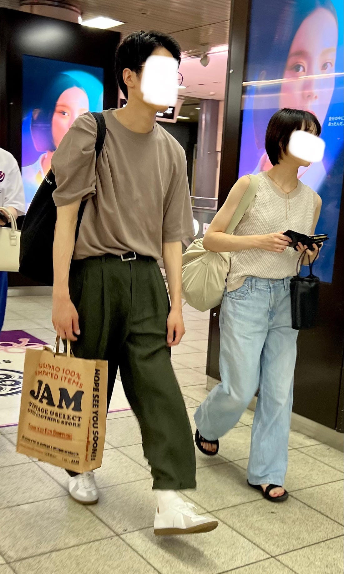 Street style photograph of a couple both wearing black and white, illustrating a classic color coordination in Japanese osoroi fashion.