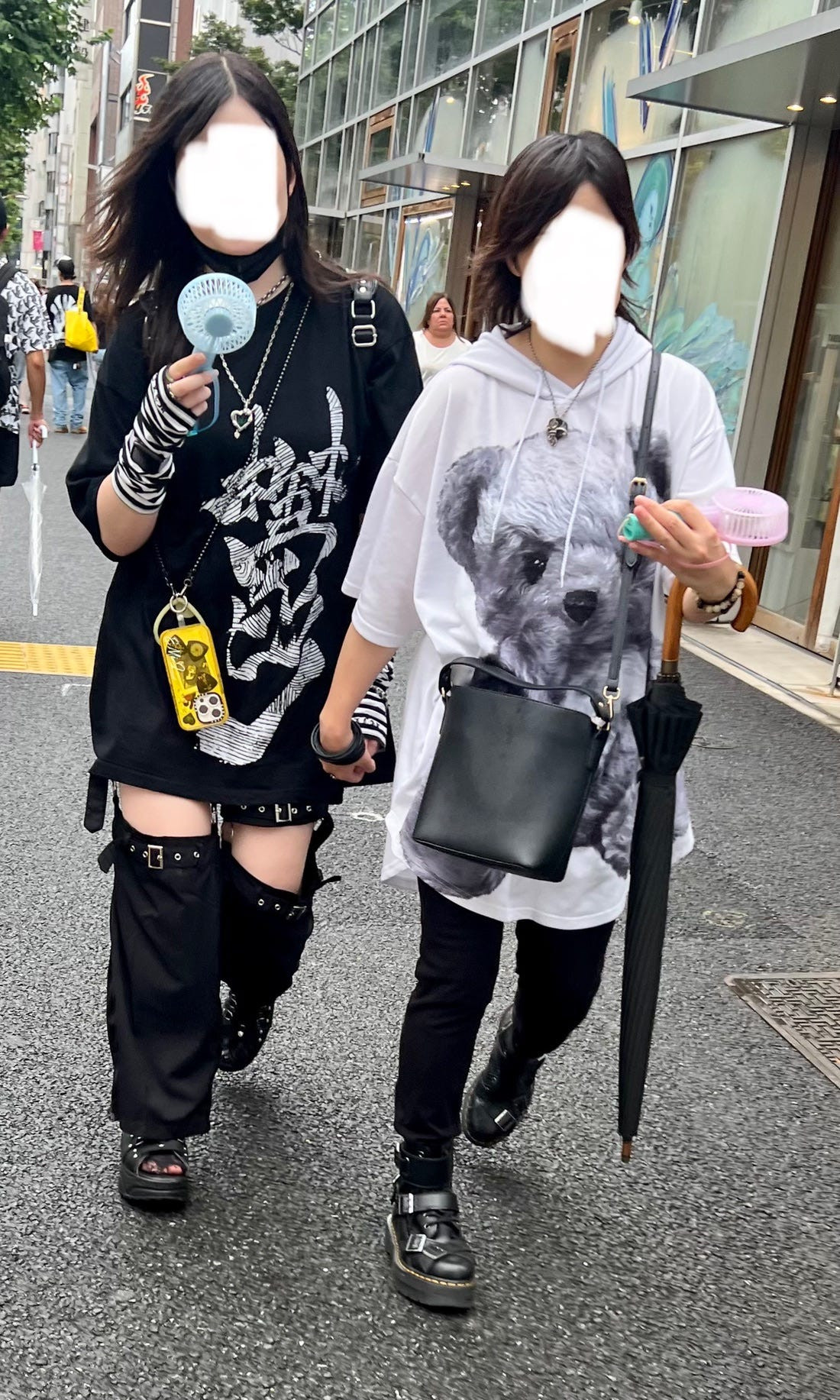 Street fashion image of a couple in subtly coordinated earth-tone outfits, illustrating a more understated approach to osoroi in Japan.