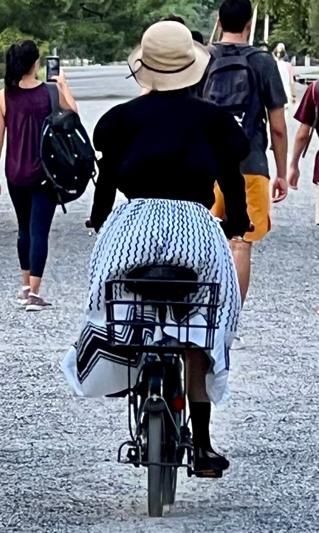 Street fashion photograph indicating tourists in shorts and leggings amidst locals with more covered styles in Japan.