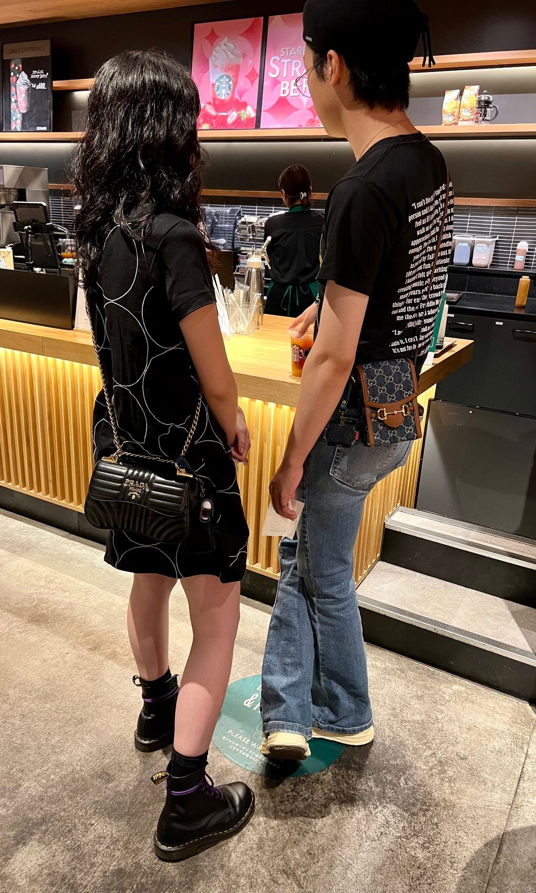 Street fashion image of a couple in matching sporty outfits, demonstrating the versatility of osoroi across different Japanese fashion styles.