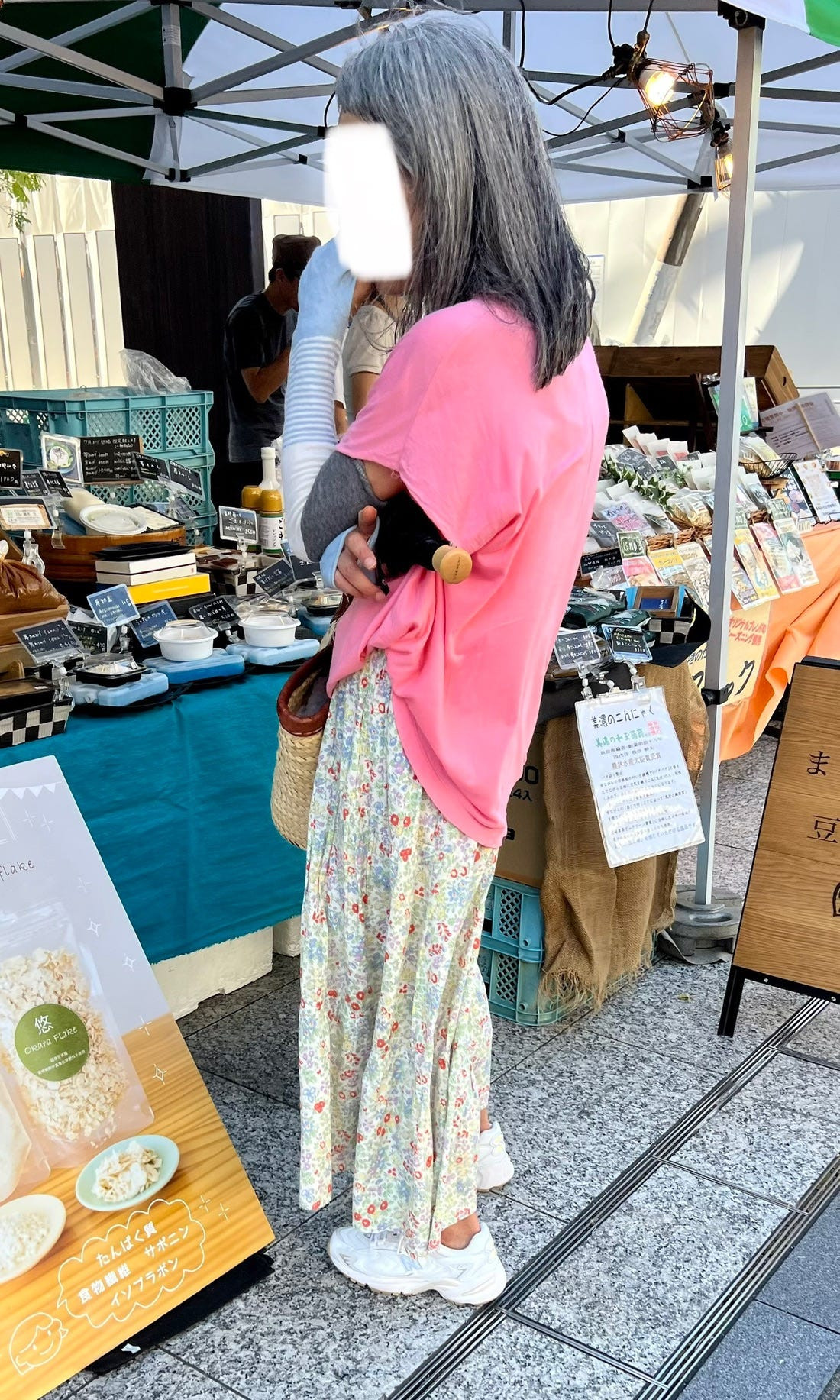 Street style image of a person wearing long sleeves and pants in summer, raising questions about modesty and sun protection in Japanese fashion.