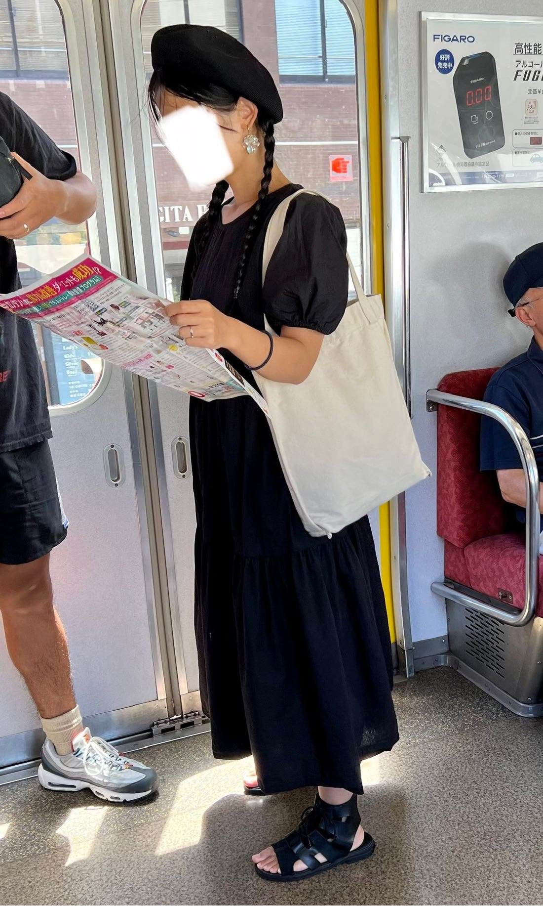 Tokyo street style image featuring a person in a bright yellow skirt and black top, demonstrating the use of color blocking in Japanese fashion.