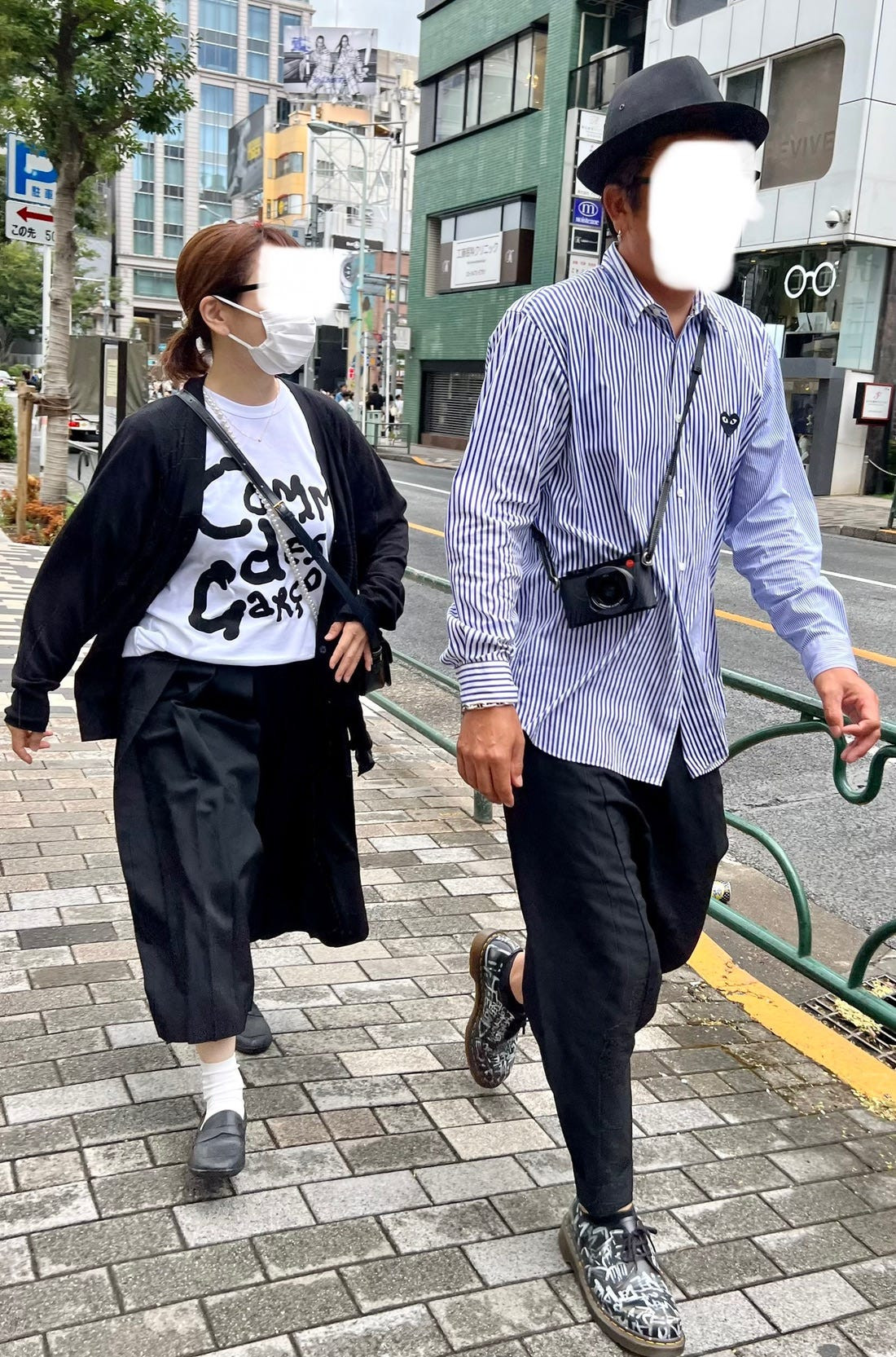 Street fashion in Osaka featuring a woman in a long black dress and platform shoes, highlighting the dramatic silhouettes often seen in Japan.