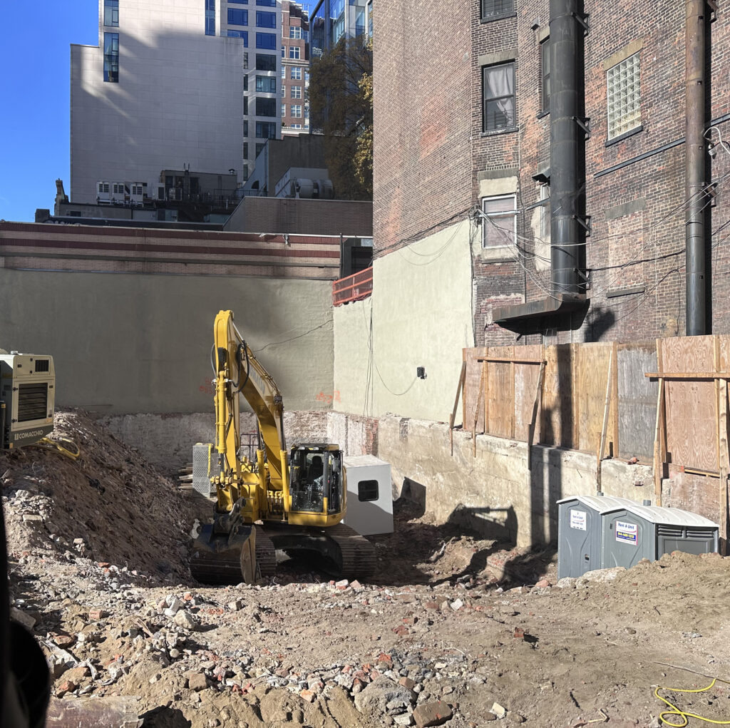 Construction site on East 86th Street with machinery and excavation in progress
