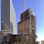 Construction progress at 25 Water Street, showcasing the steel superstructure against the New York City skyline.